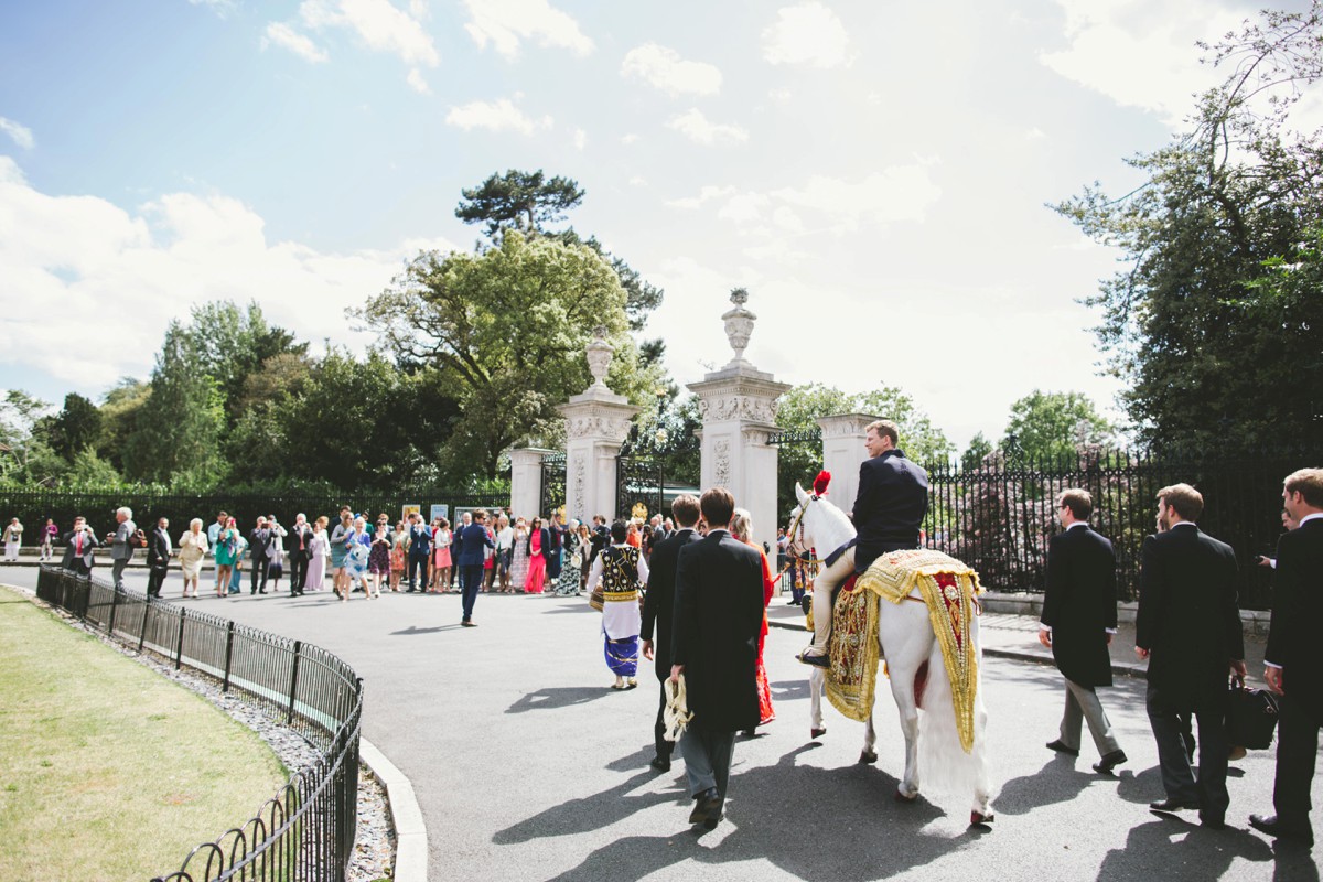 groom arrives white horse indian wedding