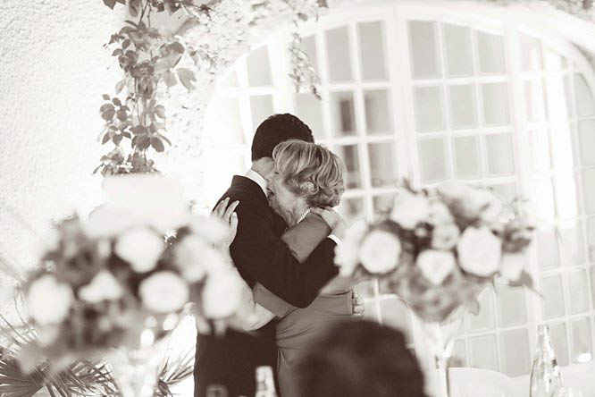 black and white photo groom and mum hug after speech