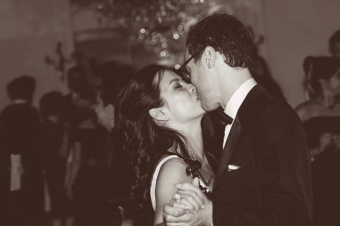 bride and groom kiss on the dance floor during their first dance