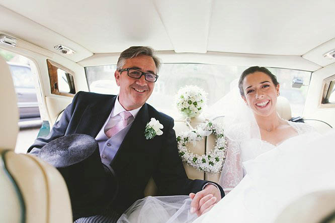 bride and her father in rolls royce wedding car