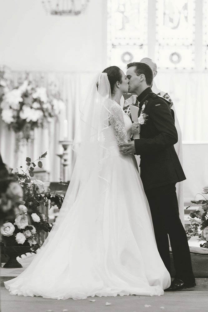 bride and groom black and white kiss