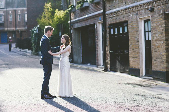 bride and groom hold hands after their mayfair wedding