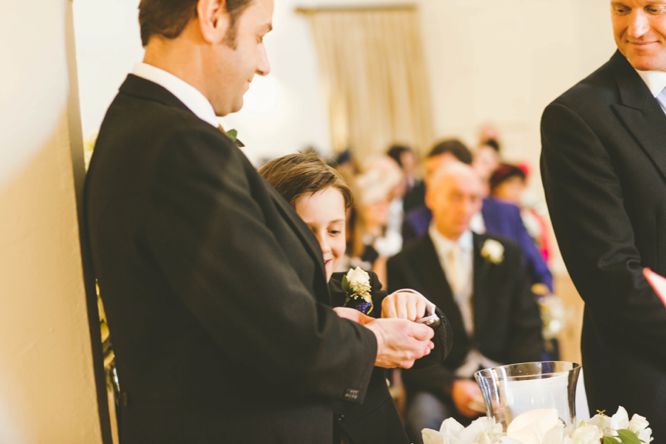 best man with rings at wedding farnham castle