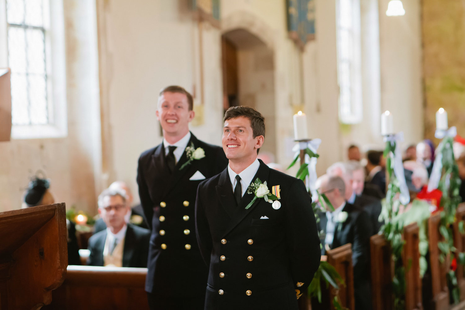 Groom waiting in church for his bride at the altar at military wedding in lulworth castle