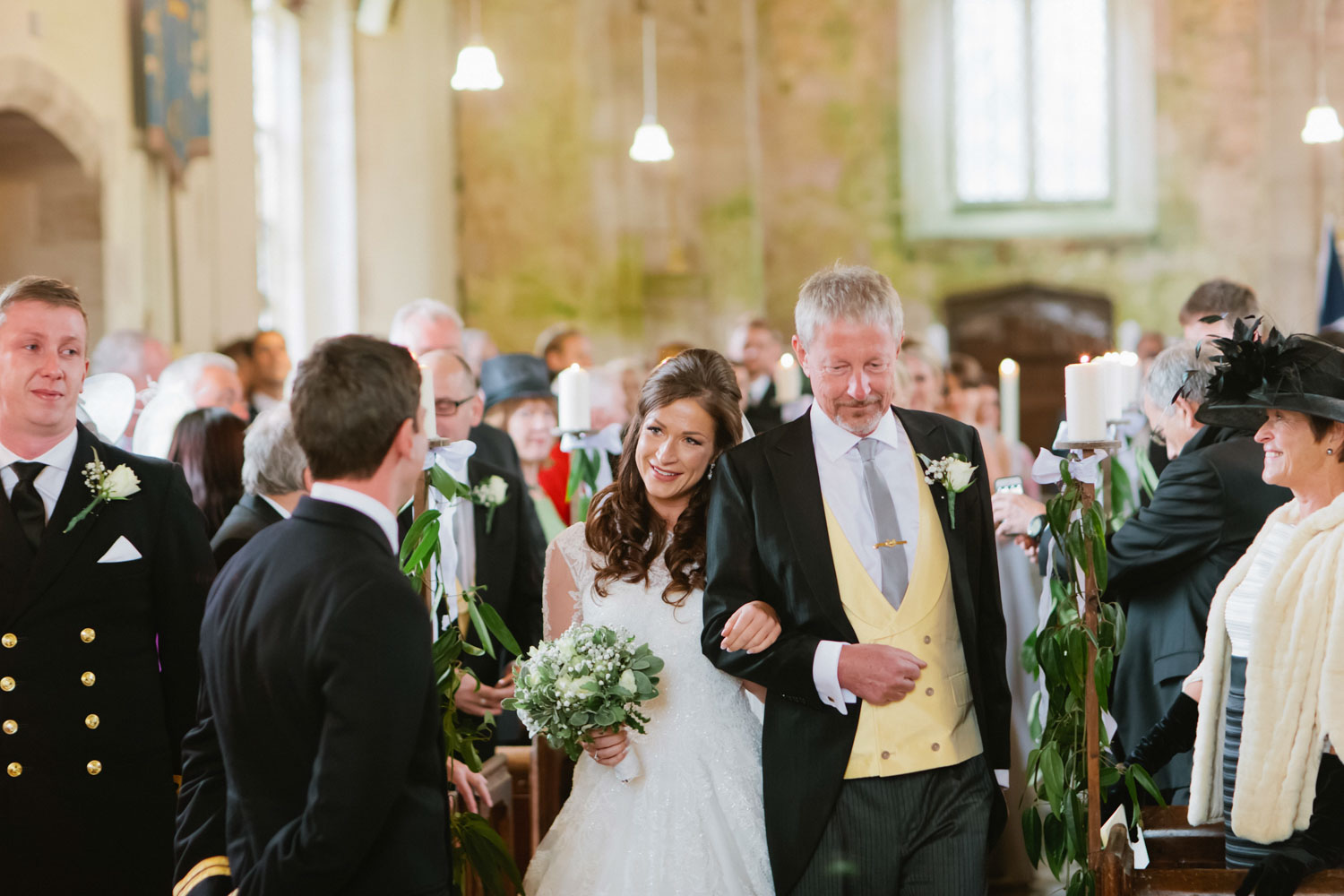 father walks his bride down the aisle in a military wedding